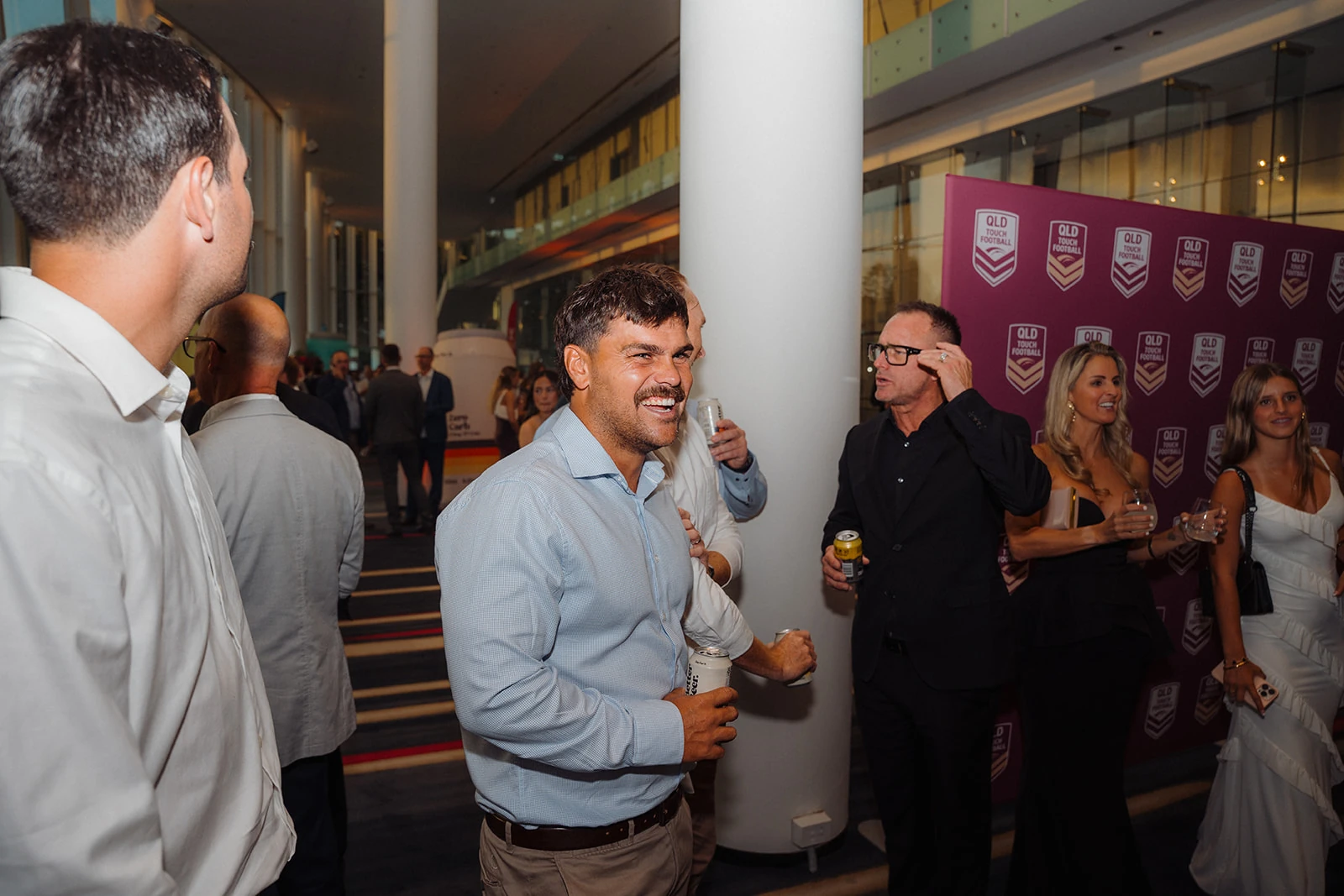 Guests laugh together in conversation before an awards evening.