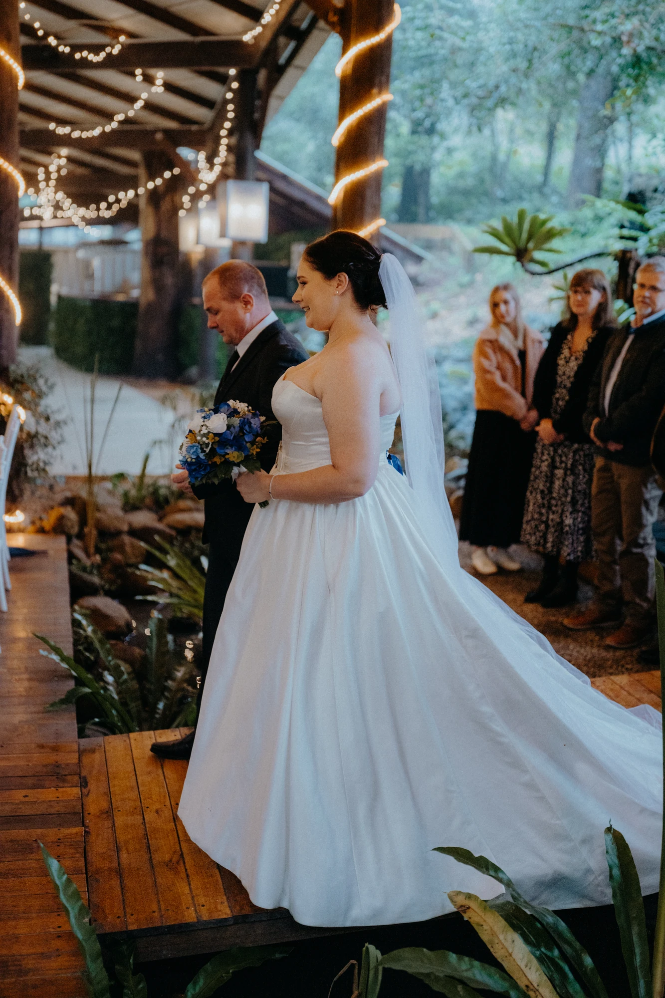 A bride walks into the ceremony holding her bouquet.