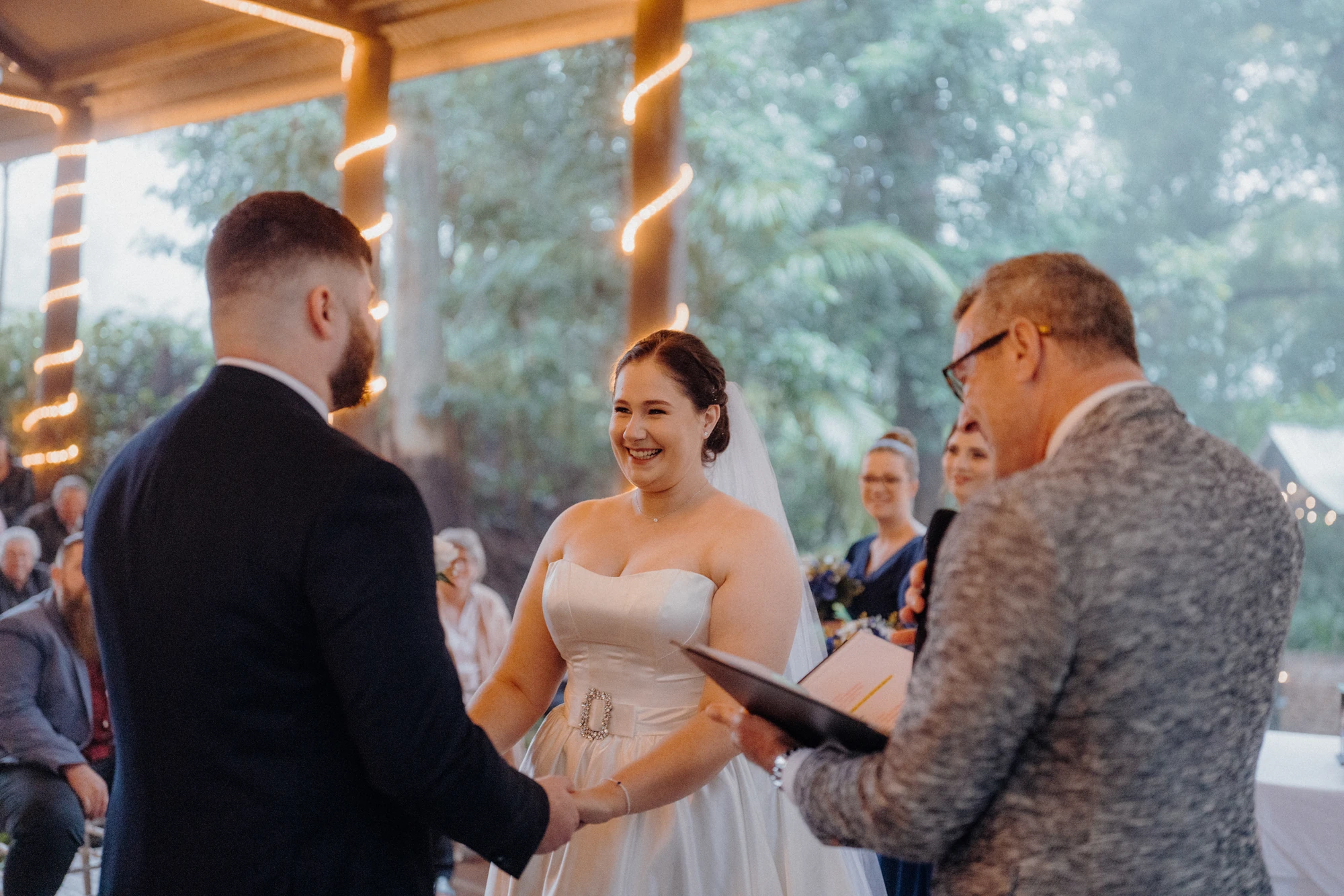 A bride smiles at her groom during the ceremony.