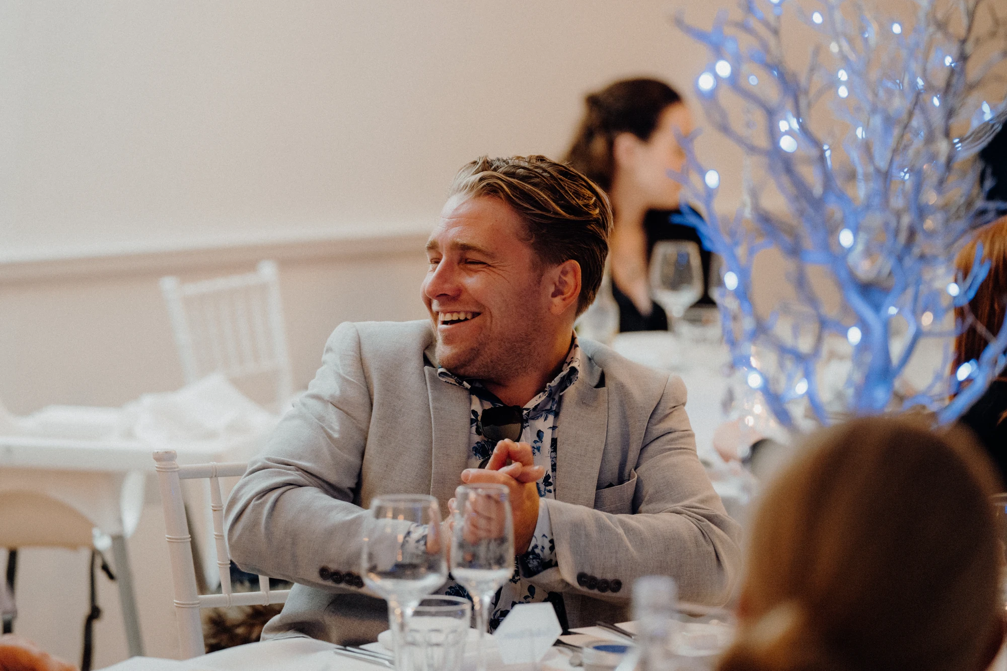 A wedding guest laughs during the reception speeches.