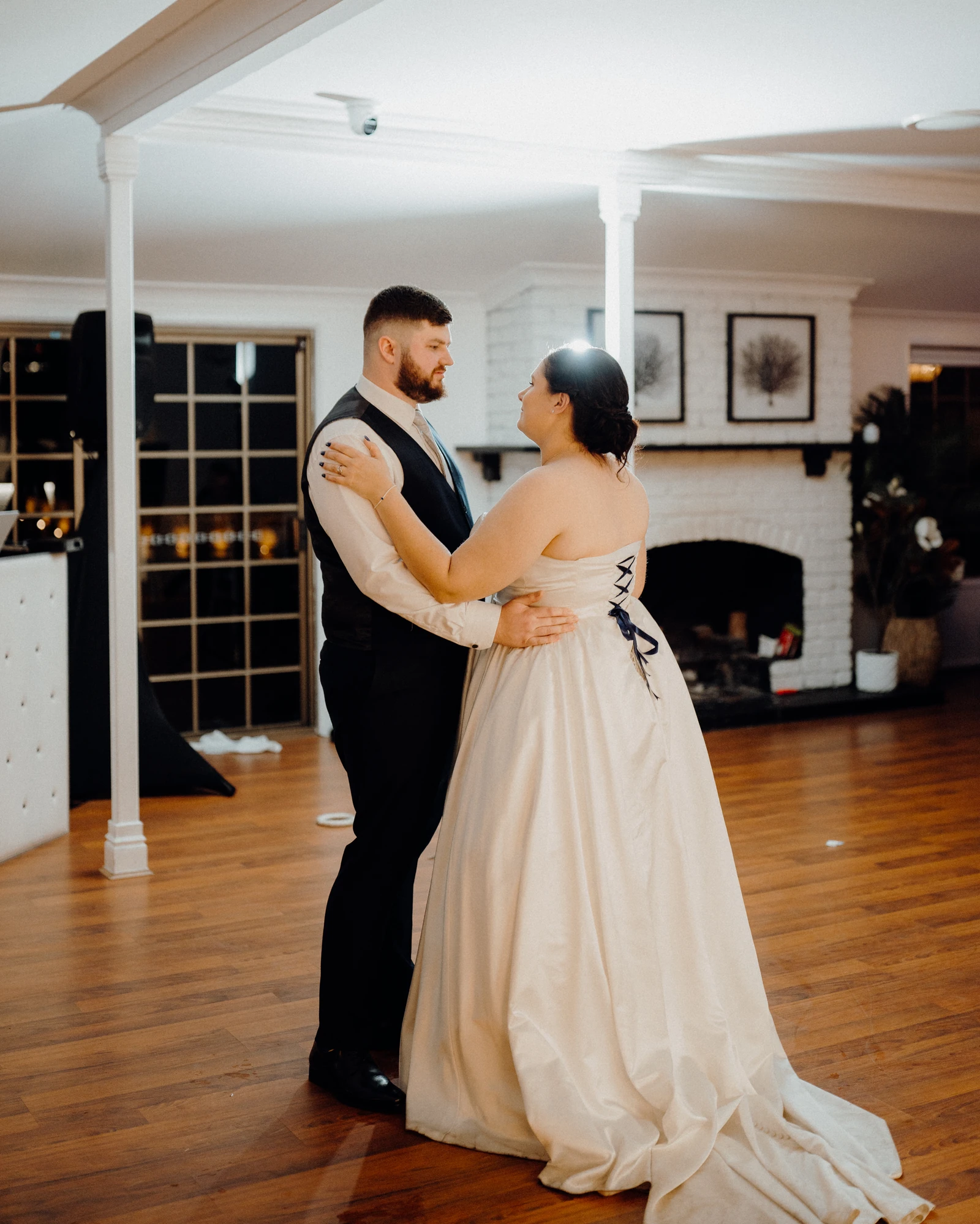 A bride and groom dance together at their reception.