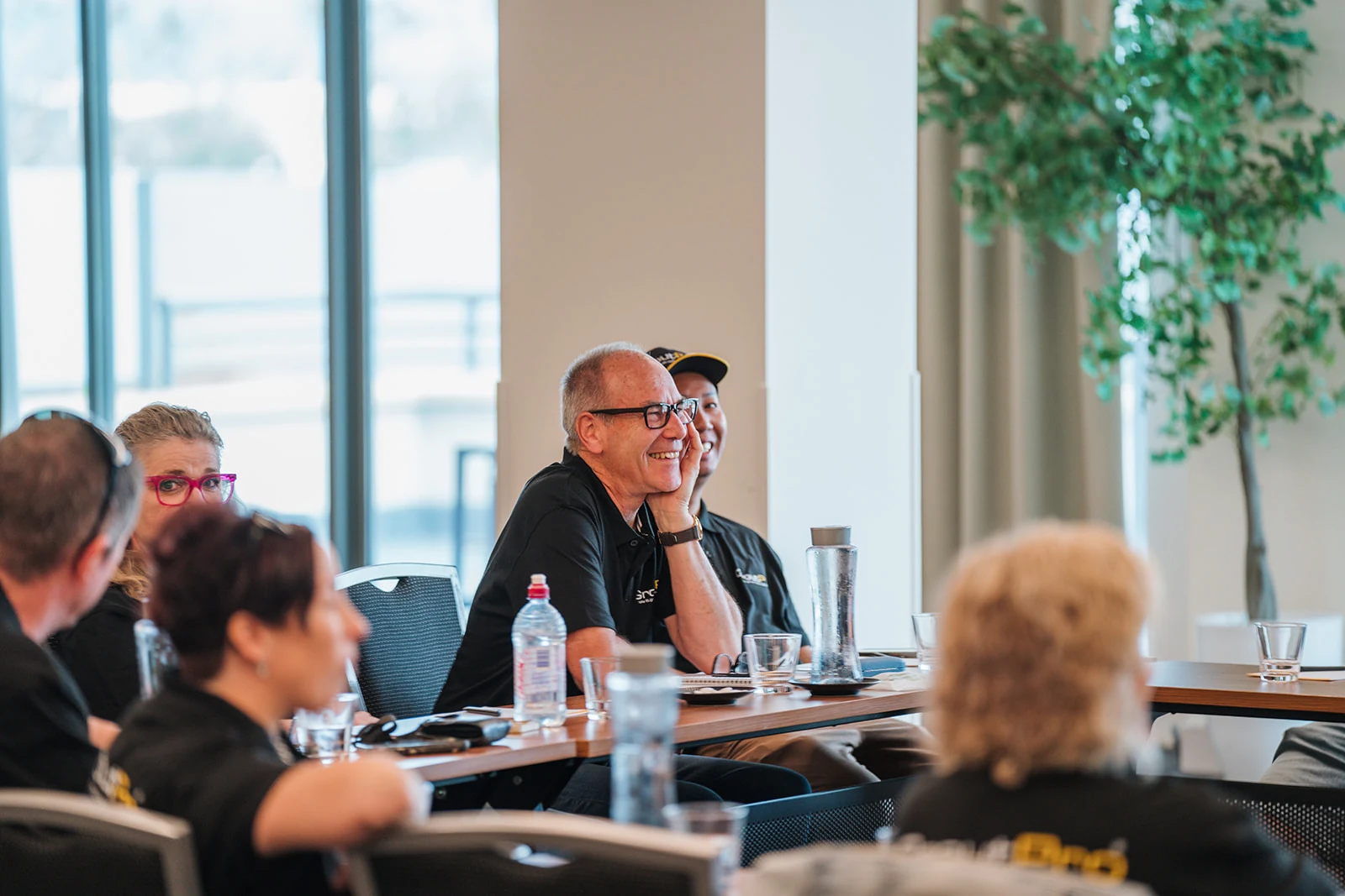 An attendee laughs during a conference discussion.