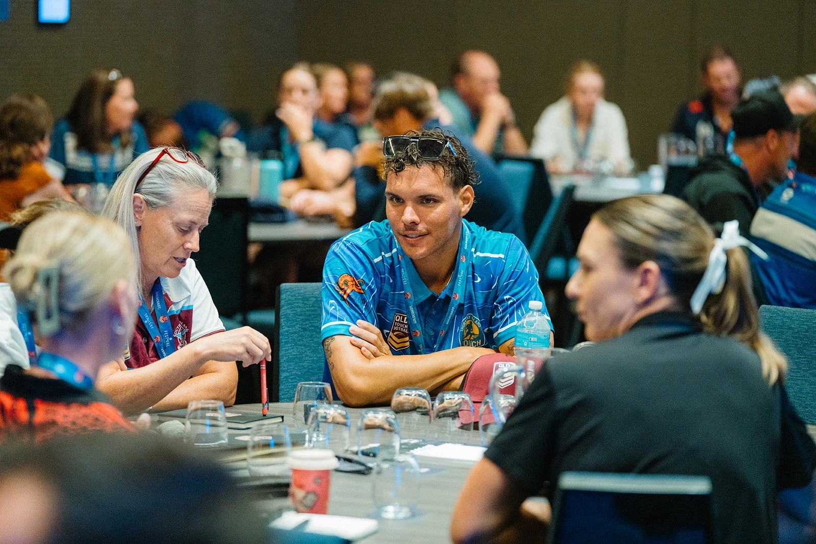 Conference attendees work together around a table.