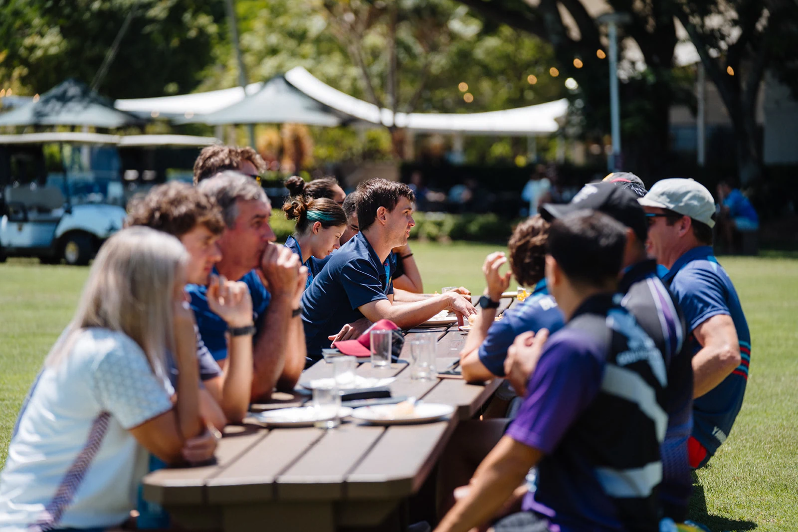 A long picnic table brings conference attendees together in the sunshine.